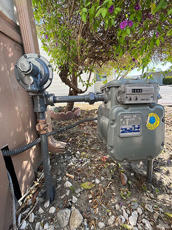 Gas meter and regulator piping outside a home