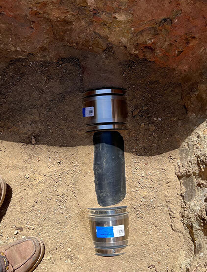Underground sewer line repair with stainless-steel couplings
