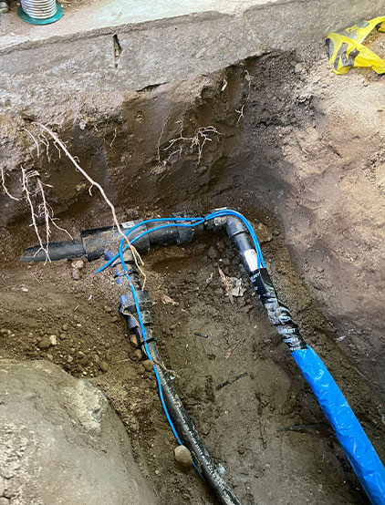 Buried pipe repair in a trench after root removal